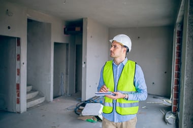 Construction worker completing an audit of the site. 